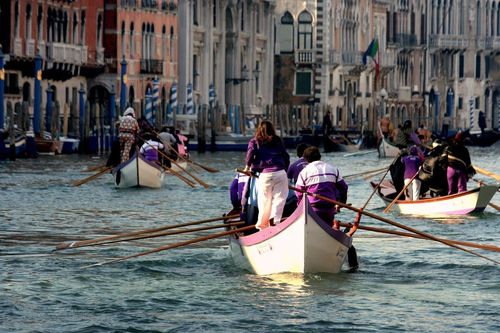 Venice is known for boat races during Ferragosto, with cheering crowds along the canals.